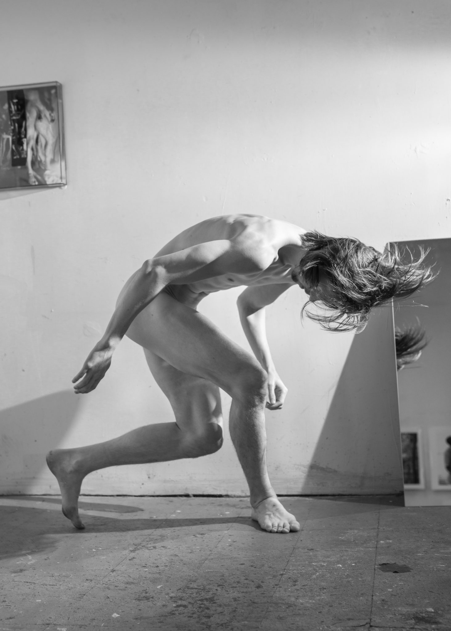 Black and white photograph of a male nude dancing by Bryson Rand
